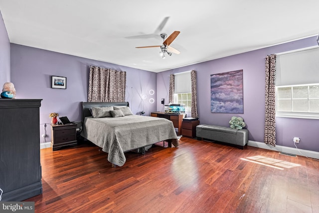 bedroom featuring wood finished floors, baseboards, and ceiling fan