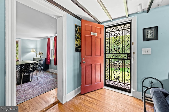 foyer with hardwood / wood-style floors and baseboards
