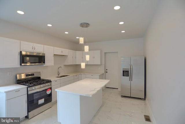 kitchen with stainless steel appliances, a sink, light marble finish floors, recessed lighting, and light countertops