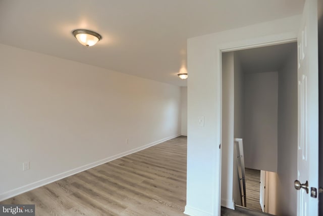 unfurnished room with wood finished floors and baseboards