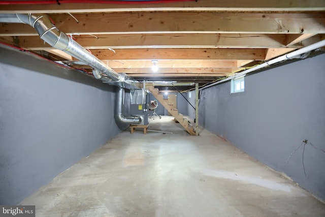 basement with stairs and heating unit