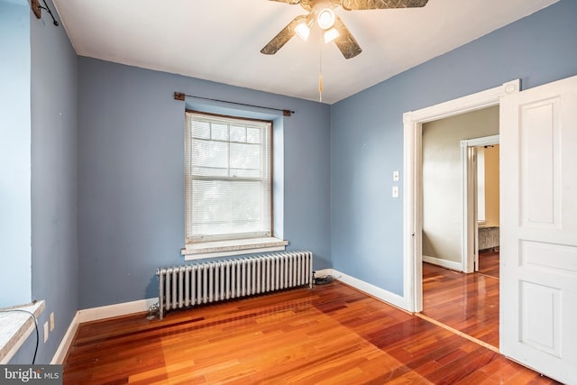 1050 Moravia St, Fountain Hill, PA 18015 - spare room featuring a ceiling fan, radiator, baseboards, and wood finished floors