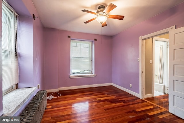 1050 Moravia St, Fountain Hill, PA 18015 - unfurnished bedroom with baseboards, ceiling fan, radiator heating unit, and wood-type flooring