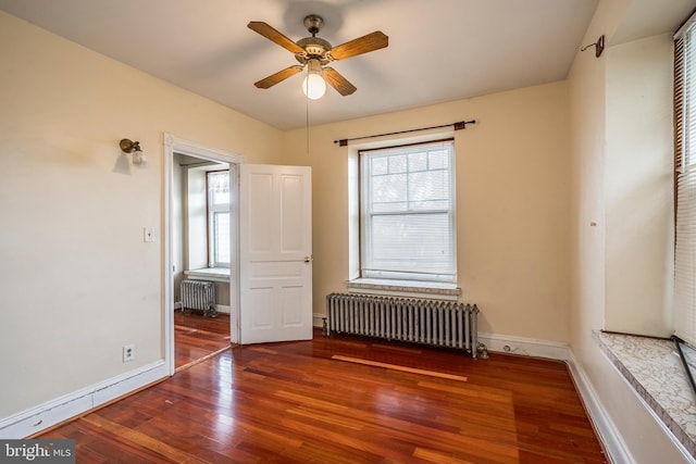 1050 Moravia St, Fountain Hill, PA 18015 - empty room featuring a ceiling fan, radiator, baseboards, and wood finished floors