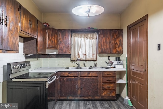 1050 Moravia St, Fountain Hill, PA 18015 - kitchen with dark wood finished floors, stainless steel electric range, a sink, light countertops, and tasteful backsplash