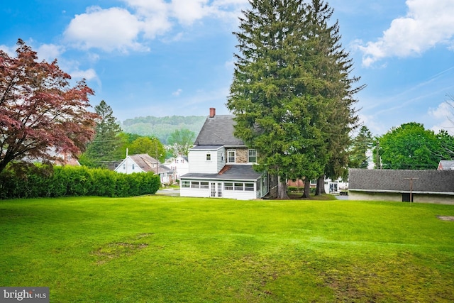1050 Moravia St, Fountain Hill, PA 18015 - rear view of property with a yard, a chimney, and a sunroom