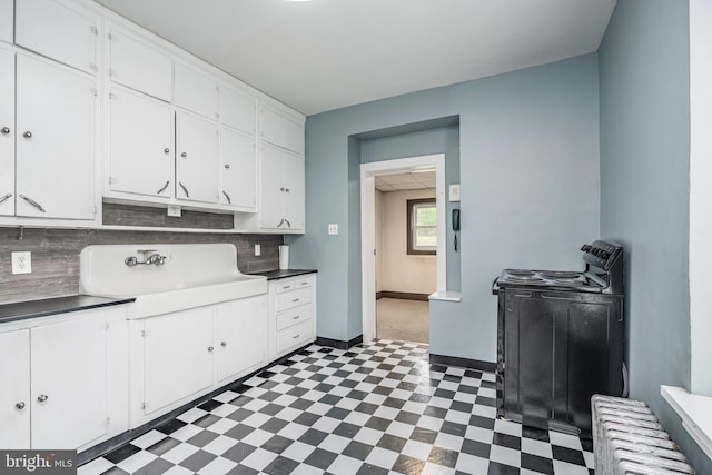 1050 Moravia St, Fountain Hill, PA 18015 - kitchen featuring tile patterned floors, white cabinetry, a sink, and electric range