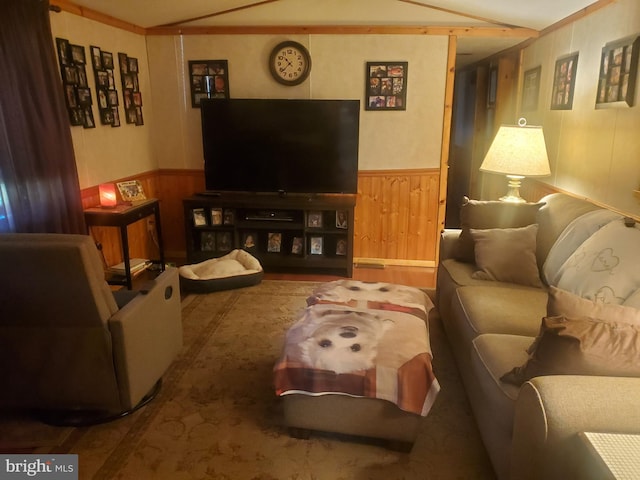 living room with a wainscoted wall and wooden walls