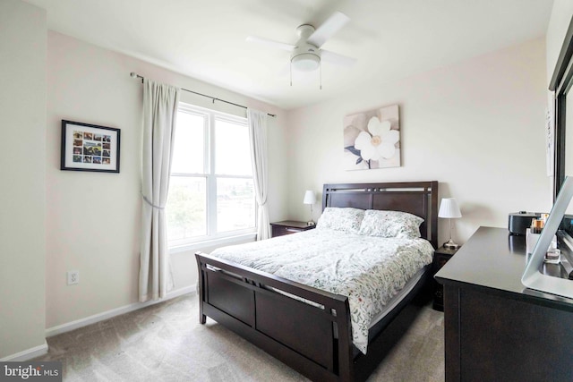 bedroom featuring baseboards, light carpet, and a ceiling fan