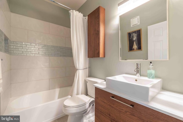 bathroom with vanity, toilet, and shower / bath combo