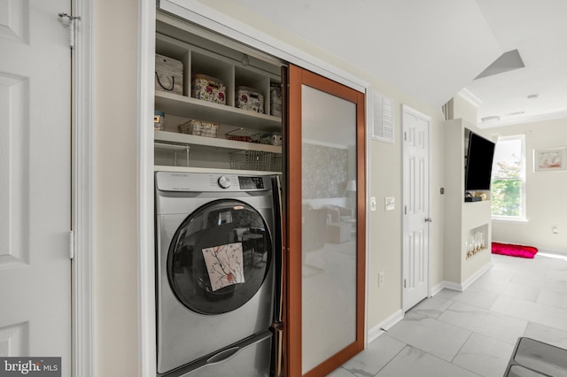 clothes washing area featuring laundry area, visible vents, baseboards, marble finish floor, and washer / clothes dryer