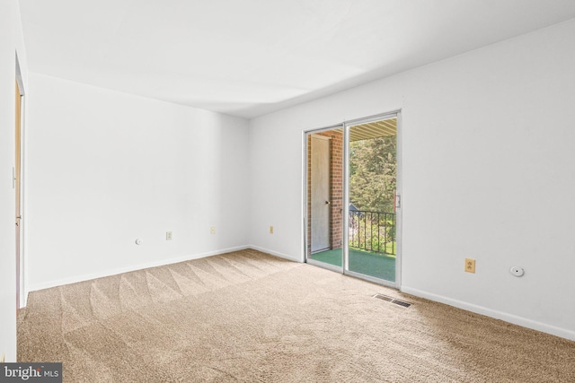 spare room with carpet flooring and baseboards