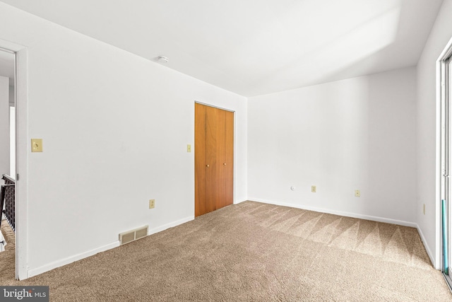 unfurnished bedroom with carpet floors and baseboards