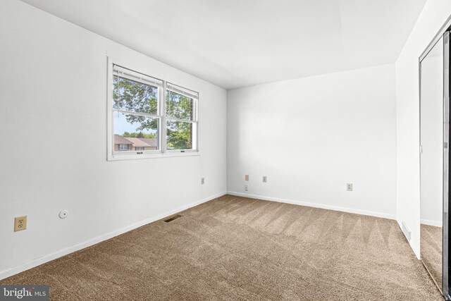 unfurnished bedroom with carpet floors and baseboards