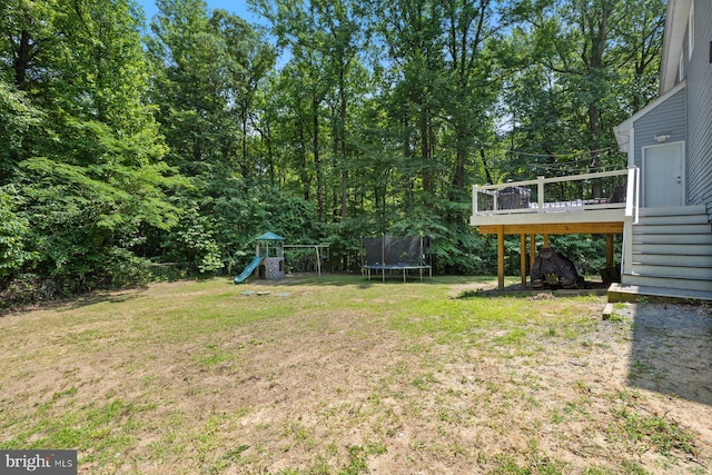 4111 Bayside Rd, Chesapeake Beach, MD 20732 - view of green lawn with a trampoline, a playground, a wooden deck, and stairway