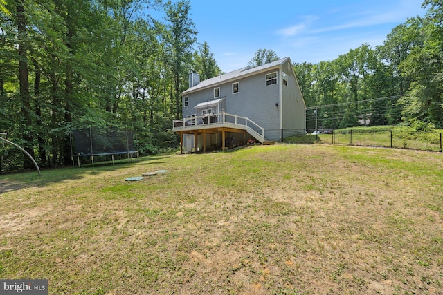4111 Bayside Rd, Chesapeake Beach, MD 20732 - back of house with a trampoline, a wooden deck, a chimney, and stairway