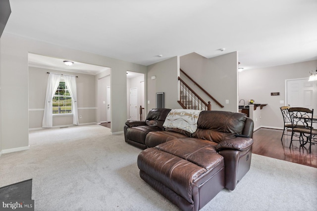 4111 Bayside Rd, Chesapeake Beach, MD 20732 - living room featuring carpet floors, stairway, and baseboards