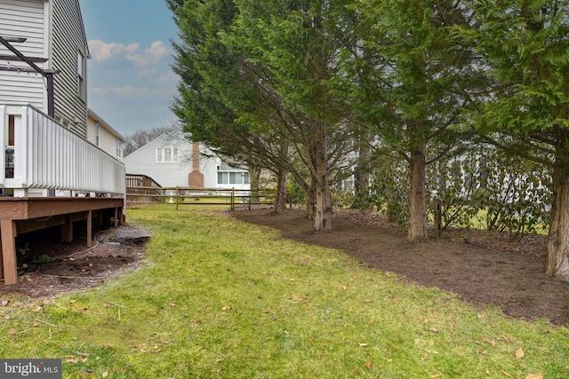 view of yard featuring fence and a deck