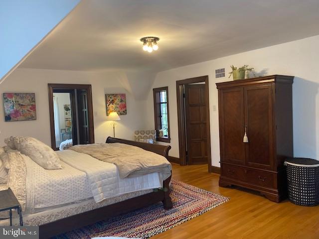 bedroom with light wood finished floors