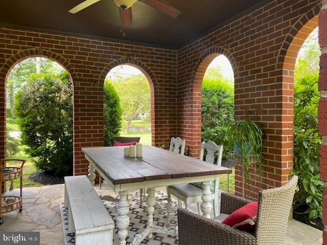 view of patio / terrace with ceiling fan and outdoor dining area