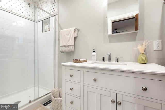 bathroom featuring a stall shower and vanity