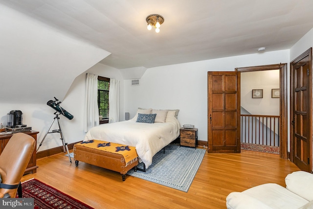 bedroom with wood finished floors and baseboards