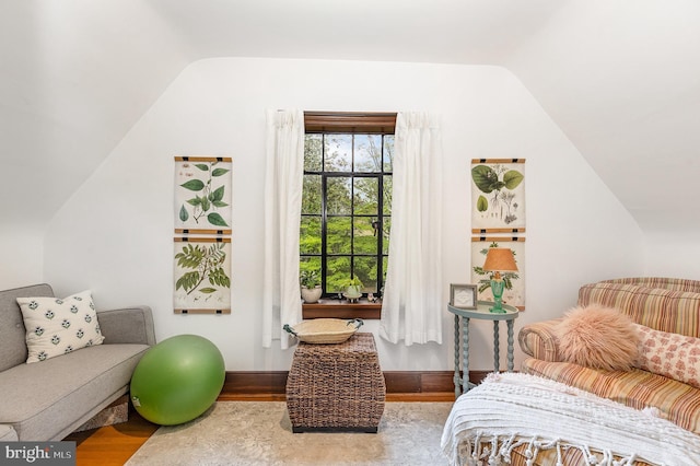 sitting room with lofted ceiling and wood finished floors