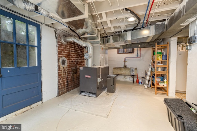 unfinished below grade area featuring heating unit and brick wall