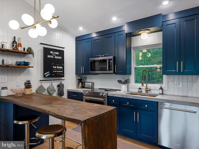 209 Hogan Dr, Basye, VA 22810 - kitchen featuring appliances with stainless steel finishes, blue cabinets, a sink, butcher block counters, and tasteful backsplash