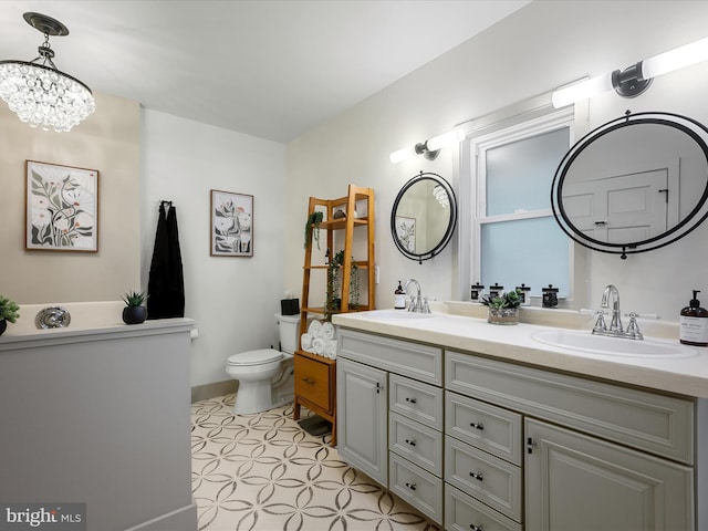209 Hogan Dr, Basye, VA 22810 - bathroom with a chandelier, double vanity, toilet, and baseboards