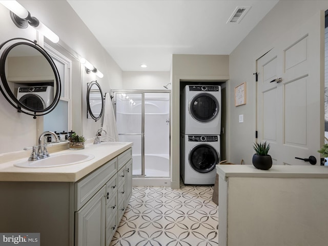 209 Hogan Dr, Basye, VA 22810 - full bath with estacked washer and dryer, a shower stall, double vanity, tile patterned floors, and recessed lighting