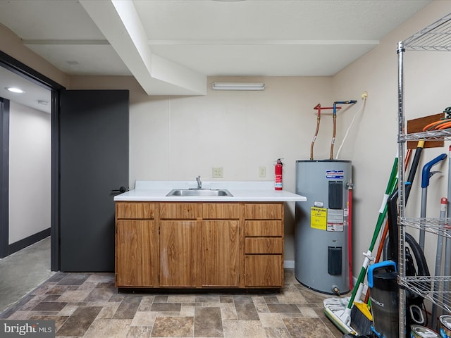 209 Hogan Dr, Basye, VA 22810 - clothes washing area featuring electric water heater, a sink, and stone finish flooring