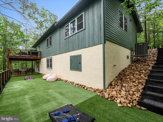 209 Hogan Dr, Basye, VA 22810 - view of side of home with central AC unit, a deck, a yard, stairway, and stucco siding