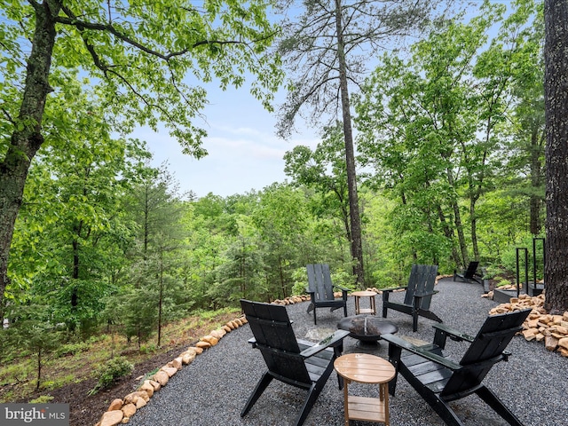 209 Hogan Dr, Basye, VA 22810 - view of patio with a fire pit and a view of trees