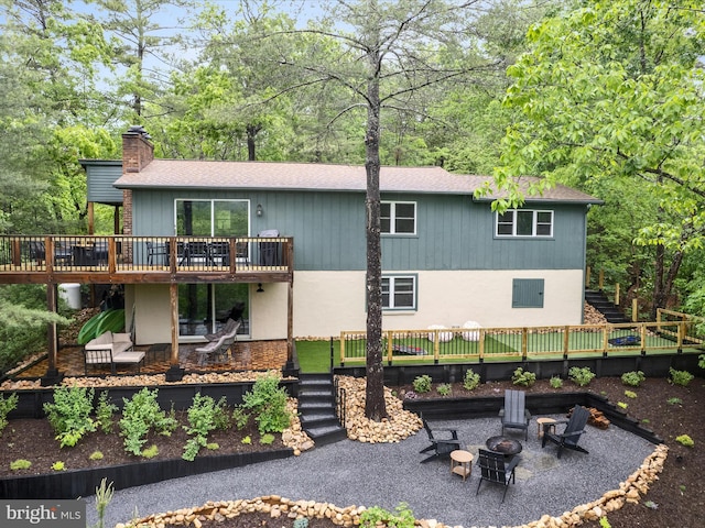 209 Hogan Dr, Basye, VA 22810 - rear view of house featuring stairs, a wooden deck, a patio, and a chimney