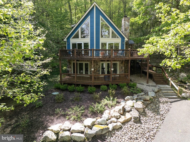 2119 Rock Lodge Rd, Mc Henry, MD 21541 - rustic home featuring a wooden deck, stone siding, stairs, a chimney, and a forest view