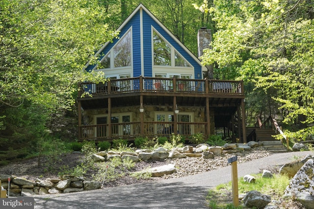 2119 Rock Lodge Rd, Mc Henry, MD 21541 - back of property featuring a wooden deck, stone siding, stairway, a chimney, and a forest view