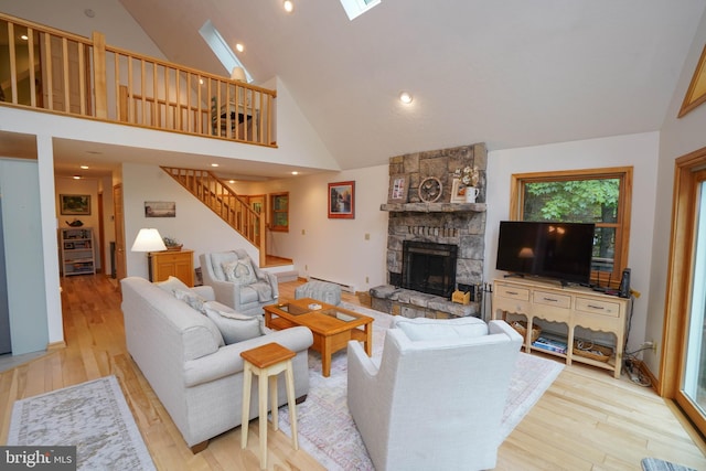 2119 Rock Lodge Rd, Mc Henry, MD 21541 - living room with stairs, a fireplace, wood finished floors, high vaulted ceiling, and baseboard heating