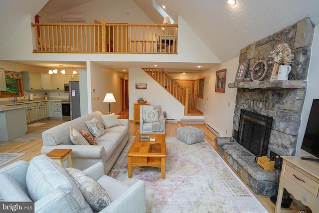 2119 Rock Lodge Rd, Mc Henry, MD 21541 - living area with light wood-style floors, high vaulted ceiling, stairway, a fireplace, and baseboard heating
