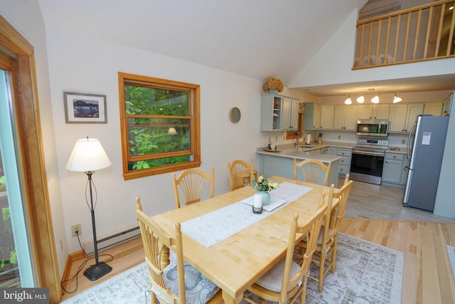 2119 Rock Lodge Rd, Mc Henry, MD 21541 - dining space with light wood-style flooring, vaulted ceiling, and a baseboard radiator