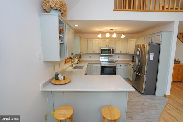 2119 Rock Lodge Rd, Mc Henry, MD 21541 - kitchen featuring appliances with stainless steel finishes, a peninsula, a sink, light countertops, and light wood finished floors