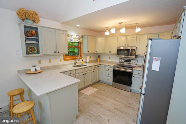 2119 Rock Lodge Rd, Mc Henry, MD 21541 - kitchen with appliances with stainless steel finishes, a sink, a peninsula, light wood finished floors, and light countertops