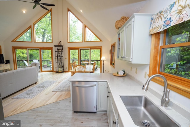 2119 Rock Lodge Rd, Mc Henry, MD 21541 - kitchen featuring dishwasher, a sink, open floor plan, high vaulted ceiling, and white cabinetry