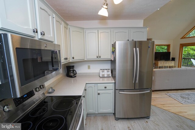 2119 Rock Lodge Rd, Mc Henry, MD 21541 - kitchen featuring stainless steel appliances, light wood-style flooring, light countertops, vaulted ceiling, and open floor plan