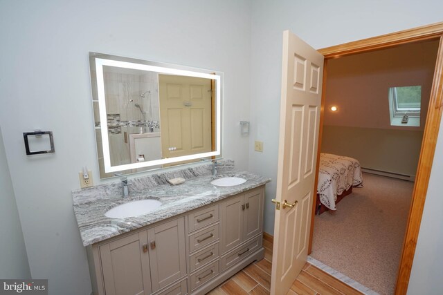 2119 Rock Lodge Rd, Mc Henry, MD 21541 - ensuite bathroom featuring a baseboard heating unit, double vanity, wood finished floors, a skylight, and tiled shower