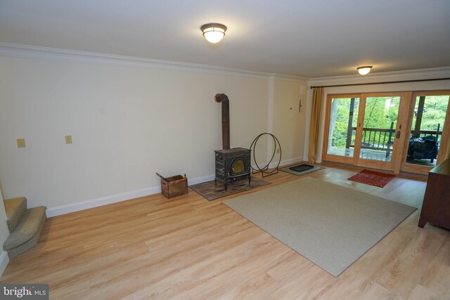 2119 Rock Lodge Rd, Mc Henry, MD 21541 - unfurnished living room featuring crown molding, a wood stove, wood finished floors, and baseboards