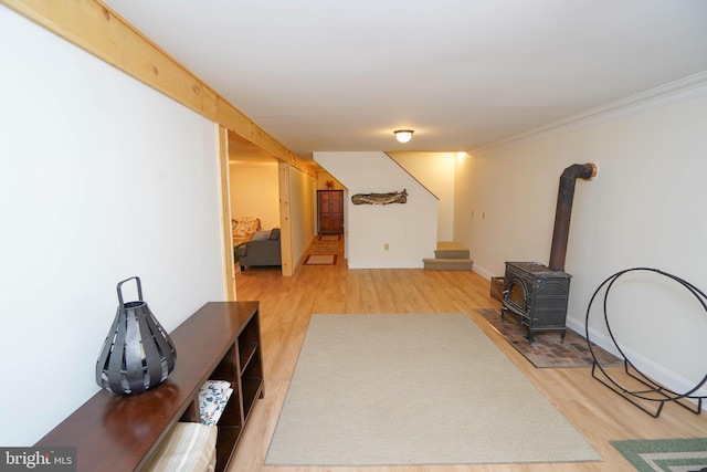 2119 Rock Lodge Rd, Mc Henry, MD 21541 - unfurnished living room with wood finished floors, stairway, a wood stove, ornamental molding, and baseboards