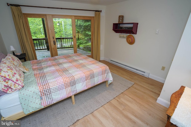 2119 Rock Lodge Rd, Mc Henry, MD 21541 - bedroom with baseboard heating, access to exterior, wood finished floors, and baseboards