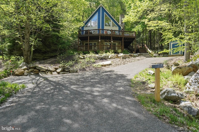 2119 Rock Lodge Rd, Mc Henry, MD 21541 - rustic home with asphalt driveway, a deck, and a wooded view