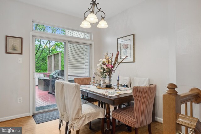 5533 Westcott Cir, Frederick, MD 21703 - dining area with wood finished floors, baseboards, and a chandelier